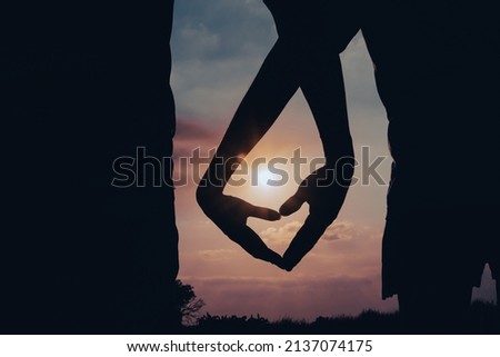 Hands shape heart silhouette romantic sunset outdoors. Royalty-Free Stock Photo #2137074175