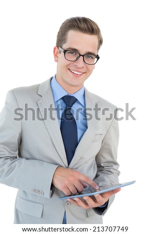 Nerdy businessman using his tablet pc on white background