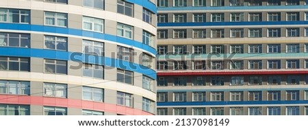 Texture, design and right geometry of new modern residetial buildings exterior in Moscow in sunny spring day. Modern construction. Close up photography. Red, yellow and white colors stripes in design