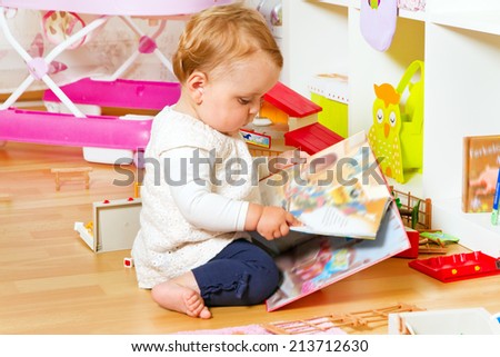 Cute baby with a colorful book