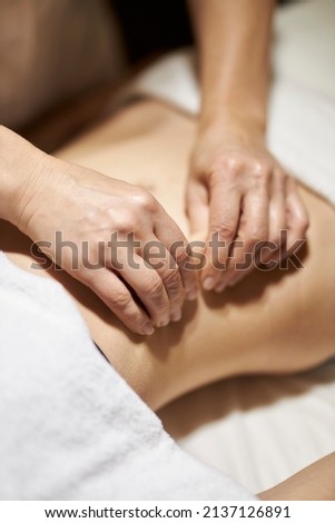 anti-cellulite massage in a beauty salon. Anti-cellulite foot massage beautiful photo. Slimming legs and hips. Masseur applying massage techniques to relax back muscles in the spa