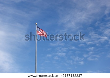 United States flag against a clear blue sky