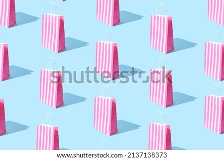 Seamless pattern made with various presents or gift bags on bright light blue background with strong shadows. Birthday concept