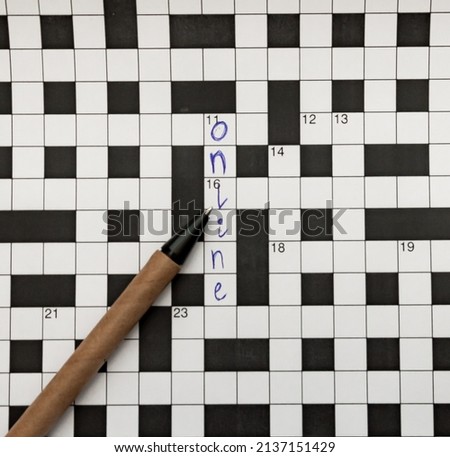 crossword puzzle with pen the word online ruchla from recycled material is written next to top view of the free space