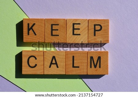 Keep Calm, words in wooden alphabet letters isolated on pastel colour background