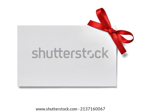 close up of a greeting card note with red ribbon on white background