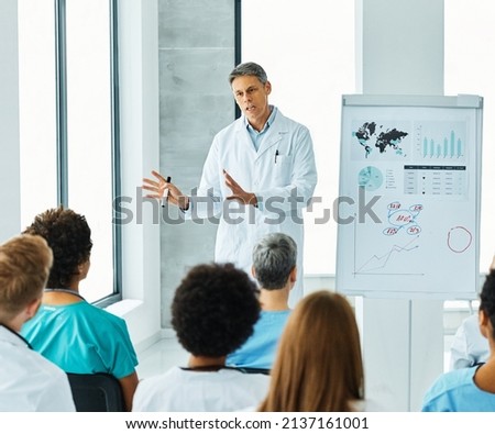 Portrait of a young doctor teaching on a seminar in a board room or during an educational class at convention center  Royalty-Free Stock Photo #2137161001