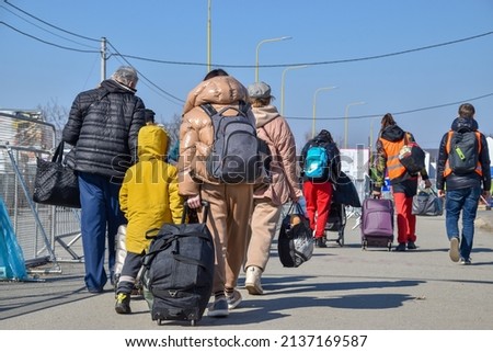 Refugees from Ukraine on the border with Slovakia. Women and children are fleeing the war in Ukraine. Volunteers on the Slovakia-Ukraine border are helping refugees.  Royalty-Free Stock Photo #2137169587