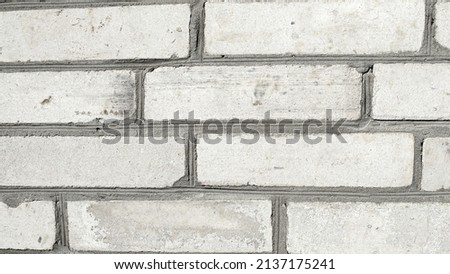 Detailed photo of a white brick wall with gray seams, a good photo for a background
