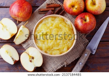 homemade apple sauce or apple puree in ceramic bowl over rustic wooden table. top view Royalty-Free Stock Photo #2137184485