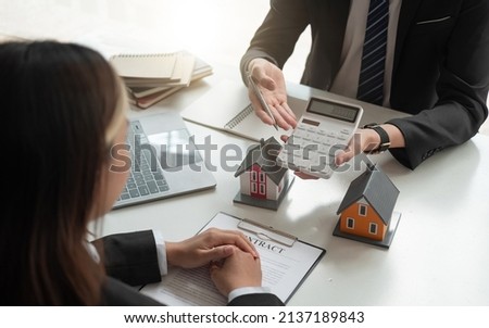 Real estate agent talked about the terms of the home purchase agreement and asked the customer to sign the documents to make the contract legally, Home sales and home insurance concept