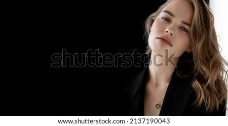 Natural look. Beauty model woman . Model test portrait with young beautiful fashion model posing on grey background. Blond woman in a black blazer . Natural makeup Royalty-Free Stock Photo #2137190043