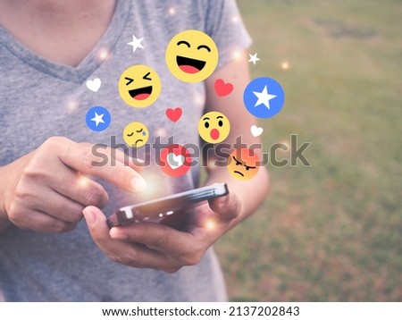 Woman using smartphone sending emoji icons, social media comment concept, emoticon with mobile phone Royalty-Free Stock Photo #2137202843