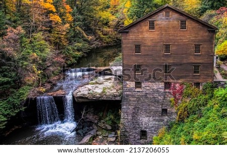 Old wooden house in the woods by the stream. Cold creek at river house in woods. Forest river house by the creek. Forest creek house Royalty-Free Stock Photo #2137206055