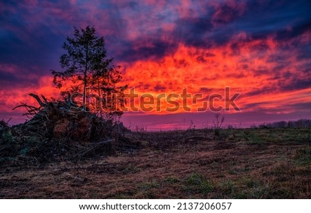 Glow in the sky at sunset. Dramatic sunset sky. Bloody glow in sunset sky. Dramatic glow in sunset cloudy sky Royalty-Free Stock Photo #2137206057