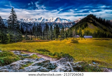 Mountain valley on a clear day. Beautiful valley in mountains. Mountain valley landscape. Snowy mountain peaks background Royalty-Free Stock Photo #2137206063