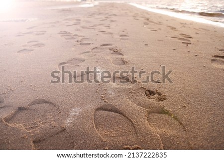 numerous shoe marks on the wet sand. travel and tourism
