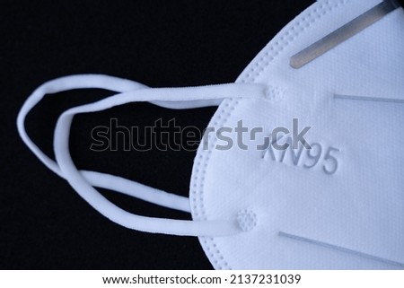 5 layer shear white KN95 FPP2 antivirus medical mask for protection against coronavirus on a black background. Doctor mask prevention of the spread of virus and pandemic COVID-19.  Royalty-Free Stock Photo #2137231039