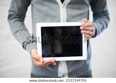 May I present.... Cropped image of a nerd holding a digital tablet.