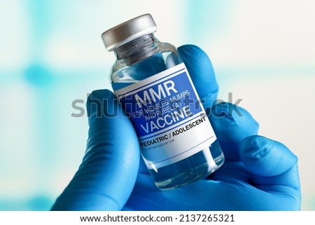 Vaccination for booster shot for MMR Measless, Mumps and Rubella diseases in the children and adolescents. Doctor with vial of the doses vaccine for MMR Measless, Mumps and Rubella diseases Royalty-Free Stock Photo #2137265321