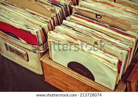 Retro styled image of boxes with vinyl turntable records on a flee market Royalty-Free Stock Photo #213728074