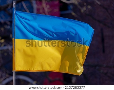 Stop the war, The national flag of Ukraine which has equally sized horizontal bands of blue and yellow, Ukraine flag hanging on the pole on the rooftop of house, Support Ukrainian from Russian attack.