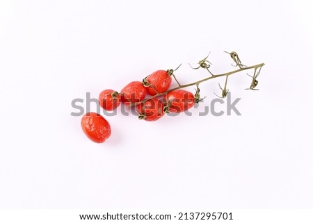 Not fresh shrivelled tomatoes on white background. Royalty-Free Stock Photo #2137295701