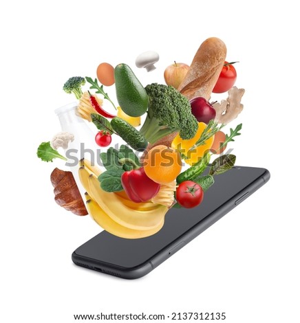 concept of online store, food delivery. Vegetables, milk, bread falling into a smartphone