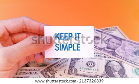 Man's hand shows a paper that says Keep It Simple. Business Finance Saving Economy Investment and Success Concept. Words typography concept. Marketing Management Motivational and communication concept