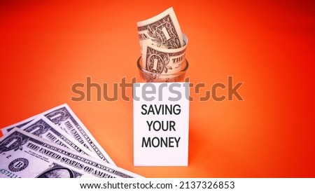 Paper that says Saving Your Money. Business Finance Saving Economy Investment and Success Concept. Words typography concept. Marketing Management Motivational and communication concept.
