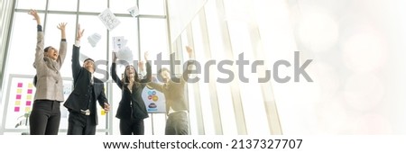 Overjoyed young asian businesspeople throw paper up in air feel excited about successful startup project happy asian colleagues have fun celebrate business success at office meeting idea web banner 