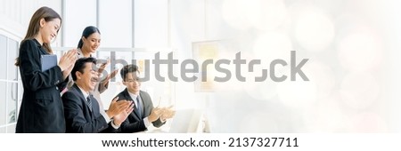 Cheerful young Asian businessman Excited and glad applauded. About successful startup projects Happy Asian colleagues celebrating business success in office meeting web banner with copy space on right