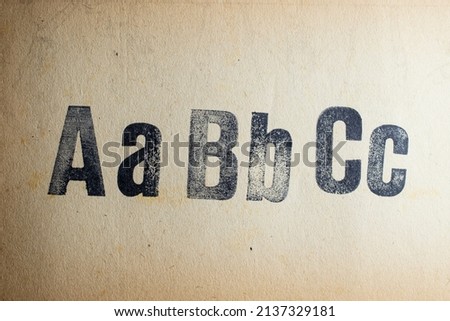 Aa Bb Cc letters stamped on vintage paper texture