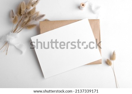 Wedding stationery invitation card mockup 7x5 on white background with envelop and boho decor. Baby shower o bridal shower mockup. Minimal bohemian style blank mockup, thank you card, greeting card