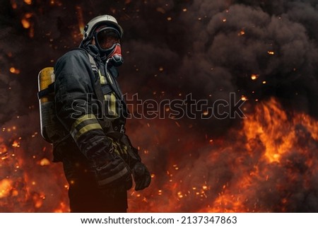 Brave firefighter dressed in special uniform with gas mask