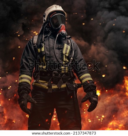 Professional firefighter dressed in special uniform with gas mask