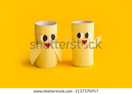 Holiday easy DIY craft idea for kids. Toilet paper roll tube toy chick baby on yellow background. Creative Easter decoration eco-friendly, reuse, recycle, zero waste handmade minimal concept. banner Royalty-Free Stock Photo #2137370957