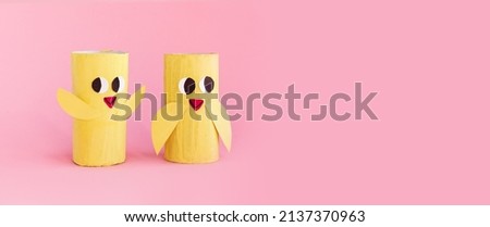 Holiday easy DIY craft idea for kids. Toilet paper roll tube toy chick baby on pink background. Creative Easter decoration eco-friendly, reuse, recycle, zero waste handmade minimal concept. banner