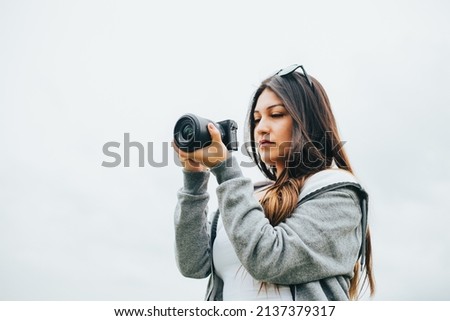 Female photographer enjoying her vacation. Concept of tourism, photography.