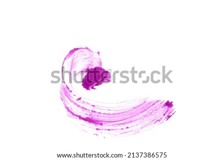 The purple color of the cosmetic product. Smudged eye shadows are isolated on a white background. Creamy texture of makeup. High quality photo