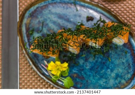 Platter decorated with different flavors of elegant  uramaki sushi. Selective focus.