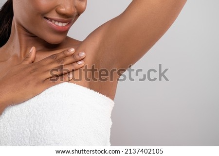 Hair Removal Concept. Unrecognizable Black Female Demonstrating Her Armpit With Smooth Skin, Smiling African American Woman Wrapped In Bath Towel Standing Over Grey Background, Copy Space Royalty-Free Stock Photo #2137402105