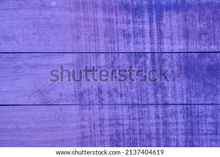 The texture of the wooden surface is purple very peri colour with horizontal lines. Texture and background. High quality photo