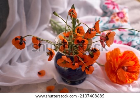 A Little Red Poppies Bouquet in blue ceramic vase