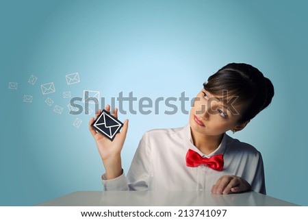 Young woman holding black card with tick