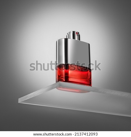 Men's perfume in a chrome bottle standing on a glass stand on a gray background