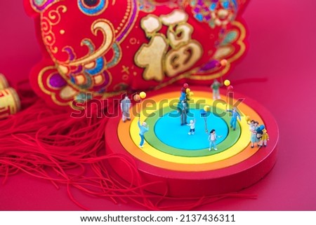 happy new year for kids playing in miniature creative festive scene.The Chinese characters in the picture mean: "Happiness"