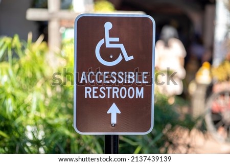 Brown Metal Accessible Restroom sign 