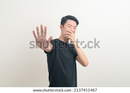 portrait young Asian with stop hand sign on white background
