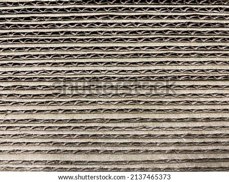 Photo of the texture of a brown cardboard sheet side view.Sale of cardboard materials.Waste paper collection.